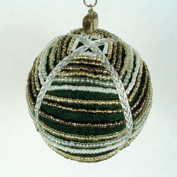 Thread ball draped with glass seed beads sewn into ribbon.